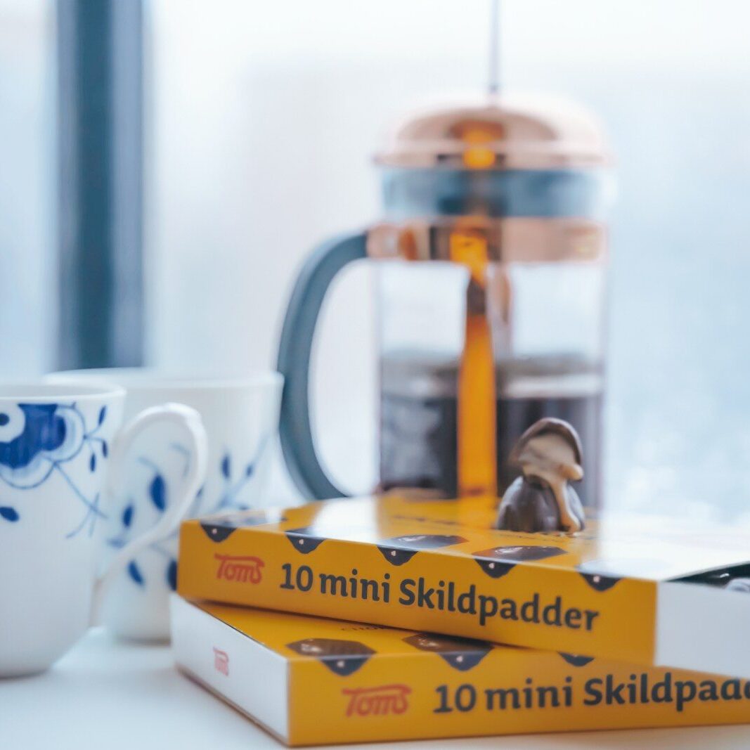 white and blue ceramic mug beside yellow and white box